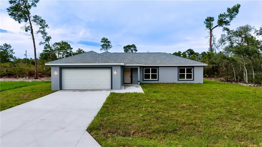 Front exterior of a new home in , Ocklawaha, FL, highlighting curb appeal (Image 1). Front exterior of a new home in , Ocklawaha, FL, highlighting curb appeal (Image 1).