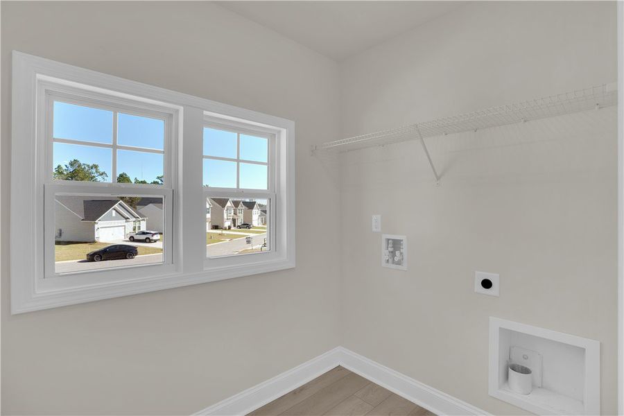 This dedicated laundry area offers ample space and This dedicated laundry area offers ample space and