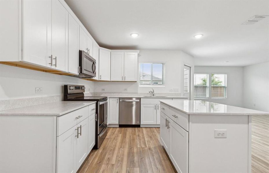 Kitchen featuring a large island ideal for informal dining and gatherings *Real home pictured