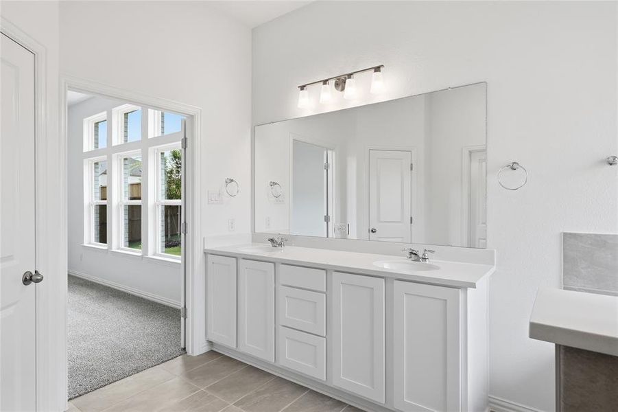 Double vanity with white cabinetry and integrated sinks