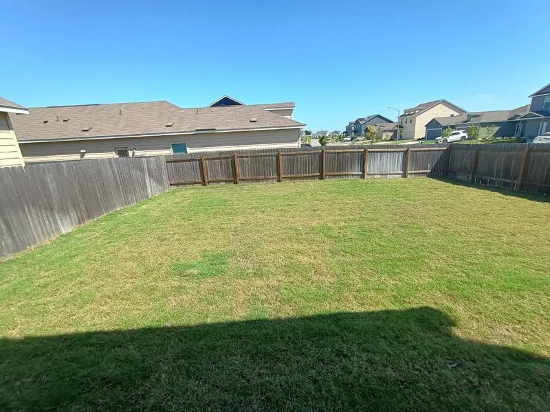 Fenced backyard featuring a residential view Fenced backyard featuring a residential view