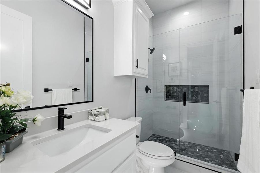 Bathroom with a shower stall and vanity Bathroom with a shower stall and vanity