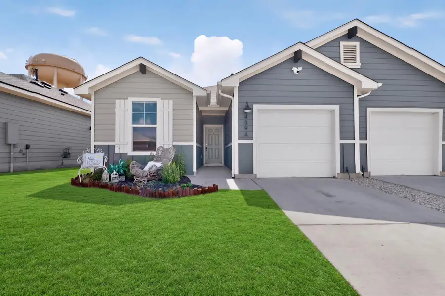 Craftsman architectural details and a manicured lawn define this welcoming modern exterior. Craftsman architectural details and a manicured lawn define this welcoming modern exterior.