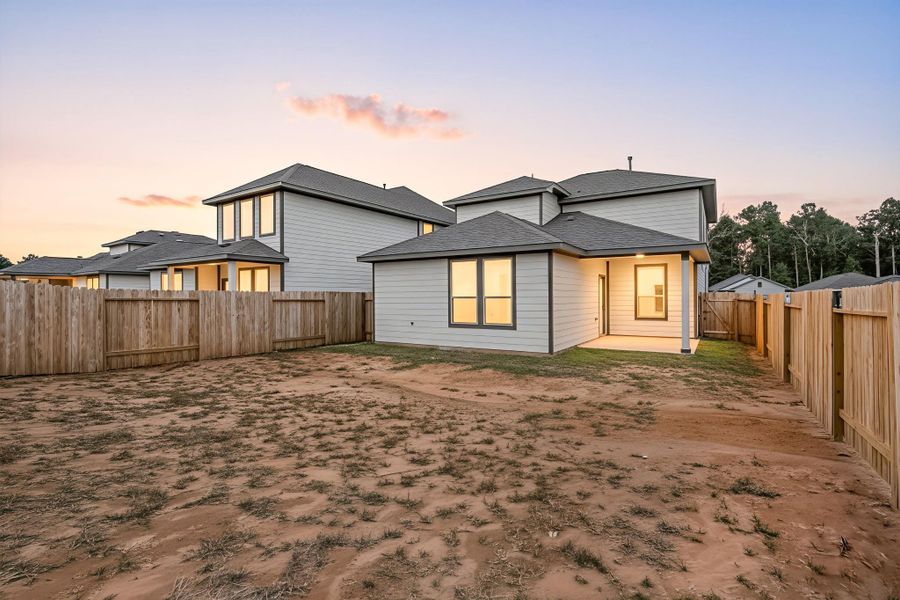 A spacious backyard with a covered patio, offering plenty of room for outdoor activities or future enhancements. The fenced-in yard provides privacy and a safe space to enjoy quiet evenings or host casual gatherings while taking in the warm glow of sunset views. A spacious backyard with a covered patio, offering plenty of room for outdoor activities or future enhancements. The fenced-in yard provides privacy and a safe space to enjoy quiet evenings or host casual gatherings while taking in the warm glow of sunset views.