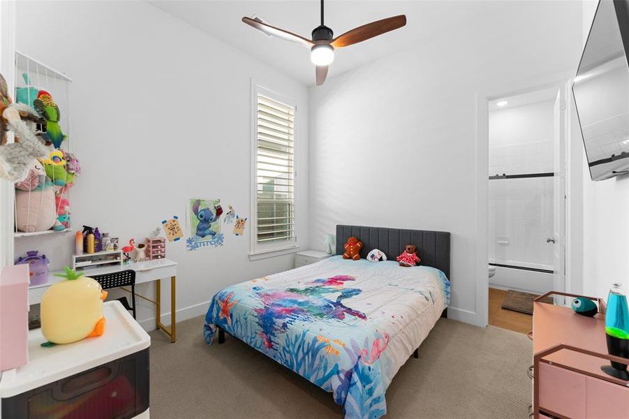 Bedroom featuring carpeted flooring, a ceiling fan with integrated lighting, and a window with white louvered blinds