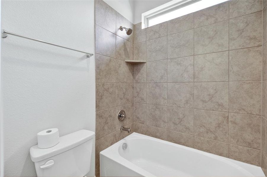 Full bathroom featuring shower / washtub combination and a textured wall