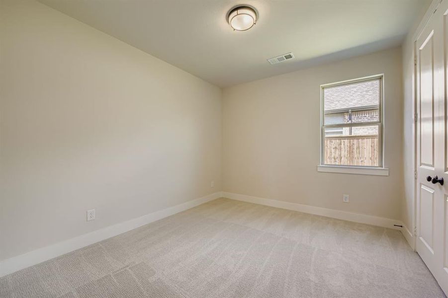 Unfurnished room featuring light colored carpet and baseboards