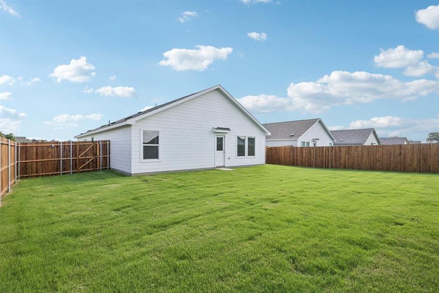Rear view of house featuring a fenced backyard Rear view of house featuring a fenced backyard