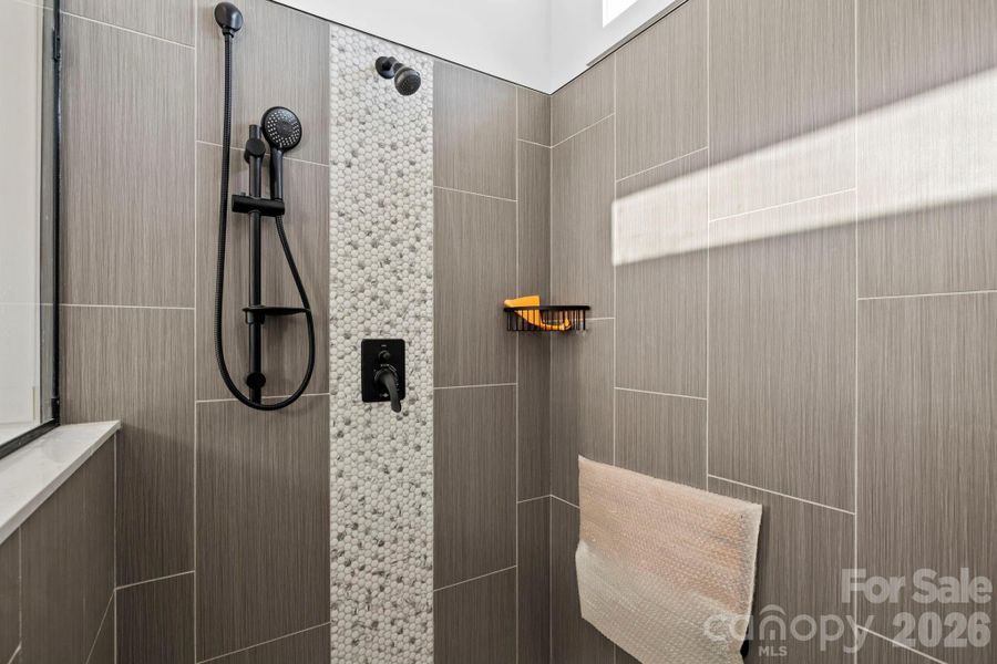 Huge tile shower w/ flip down seat and 3 shower heads!