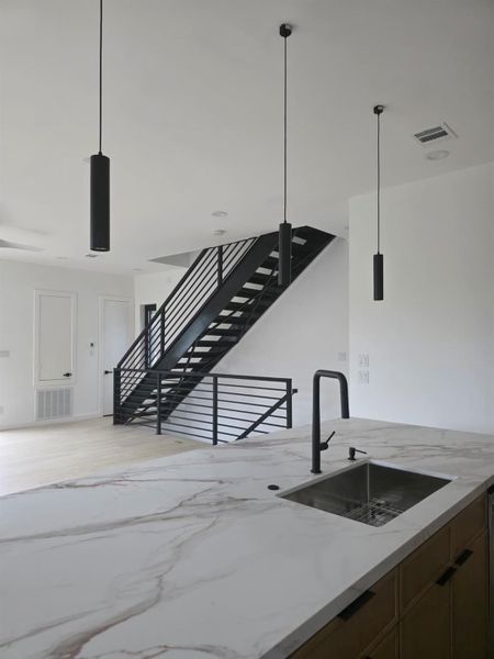 Graphite black railings are a piece of linear art cutting through the home
