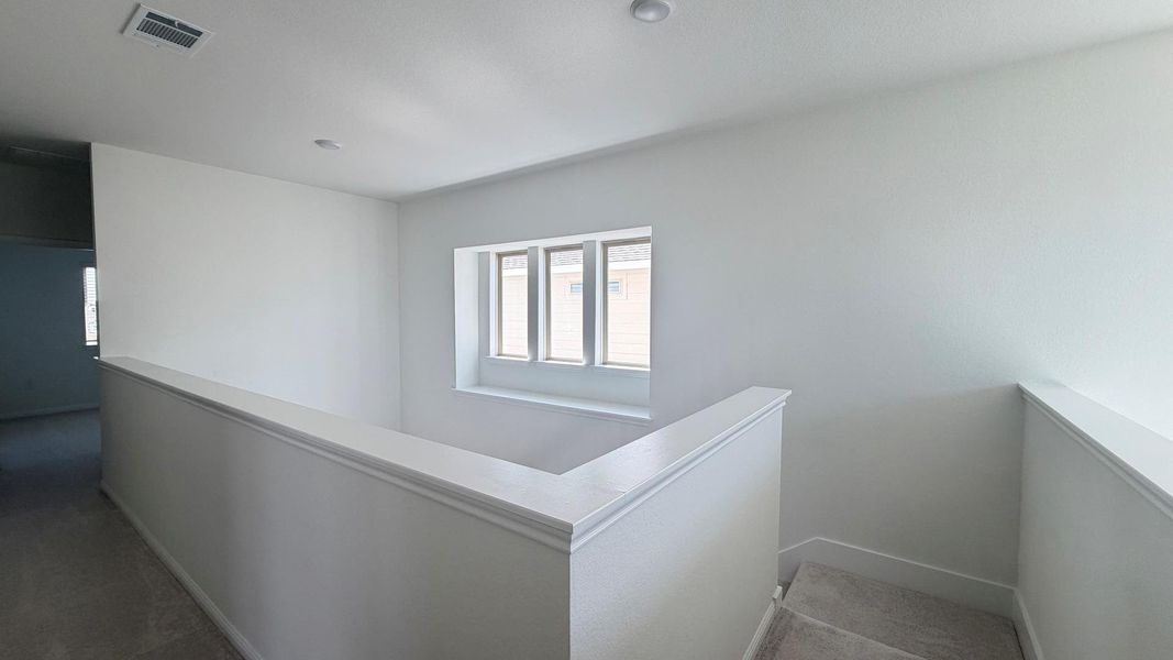 A well-lit landing and staircase provide seamless flow between levels. A well-lit landing and staircase provide seamless flow between levels.