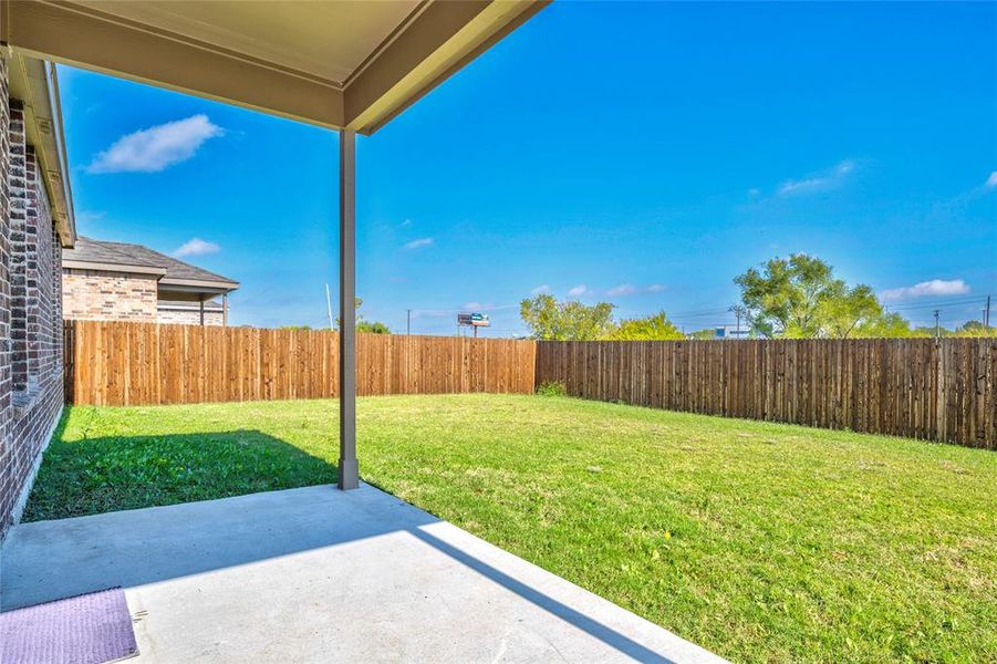 Fenced backyard featuring a covered patio Fenced backyard featuring a covered patio