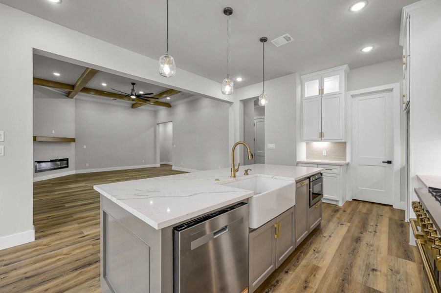 The open kitchen overlooks the living and dining areas and allows for easy entertaining. The open kitchen overlooks the living and dining areas and allows for easy entertaining.