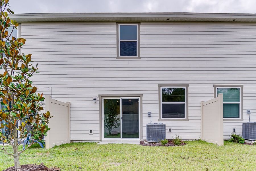 Exterior details and patio area of a home in Orchard Park Townhomes, St. Augustine (Image 2).