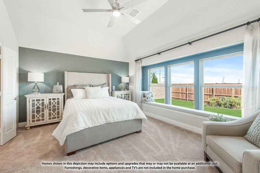 Bedroom with vaulted ceiling, ceiling fan, large windows, and teal accent wall with carpet flooring Bedroom with vaulted ceiling, ceiling fan, large windows, and teal accent wall with carpet flooring