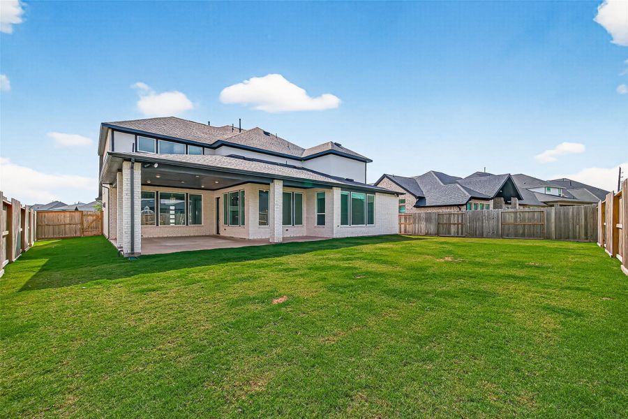Wrap around covered patio overlooks the backyard.