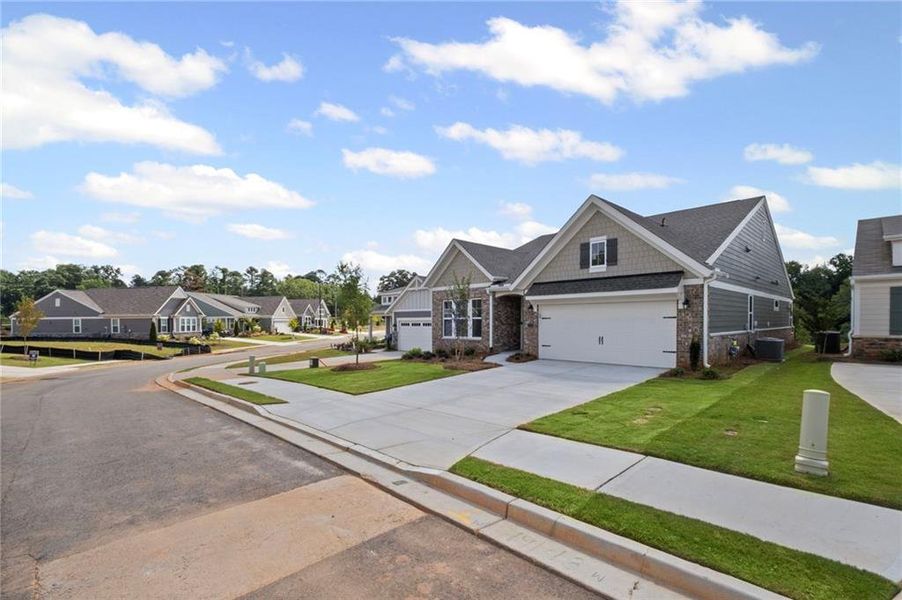 Front exterior of a new home in Laurel Farms, Dallas, GA, highlighting curb appeal (Image 23). Front exterior of a new home in Laurel Farms, Dallas, GA, highlighting curb appeal (Image 23).