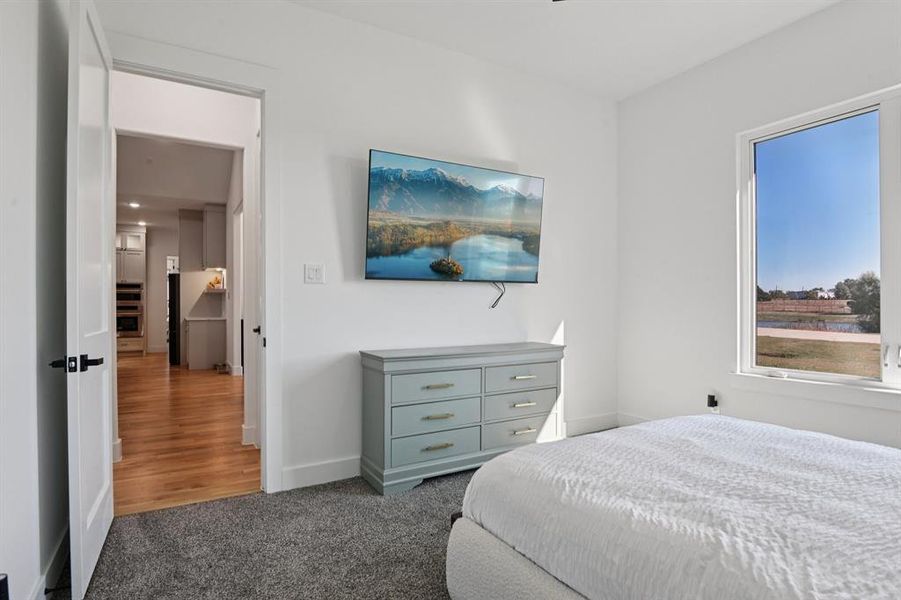 Carpeted bedroom featuring baseboards Carpeted bedroom featuring baseboards