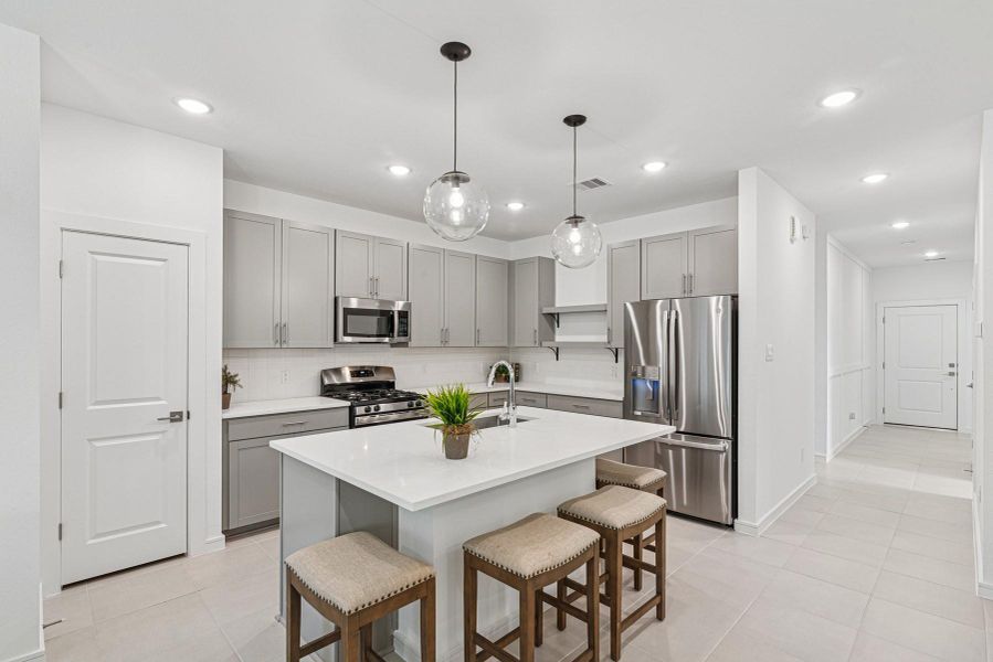 Stunning island kitchen with grey cabinets and quartz countertop Stunning island kitchen with grey cabinets and quartz countertop