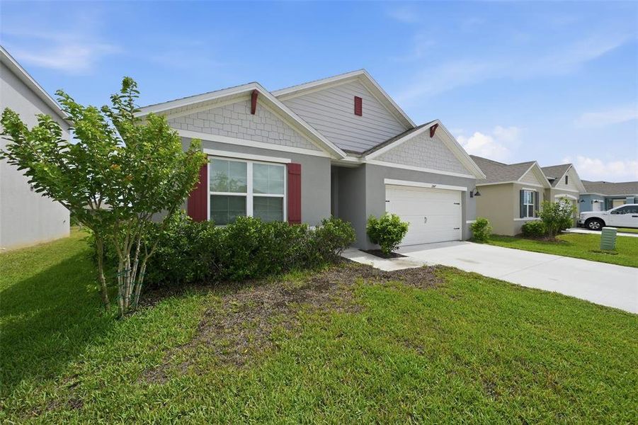 Front exterior of a new home in Harmony West, St. Cloud, FL, highlighting curb appeal (Image 23). Front exterior of a new home in Harmony West, St. Cloud, FL, highlighting curb appeal (Image 23).
