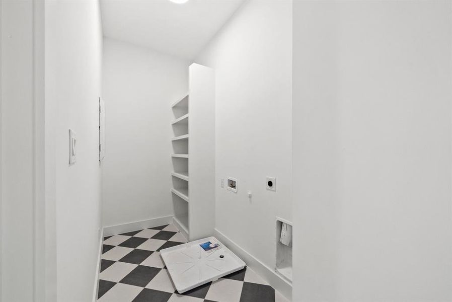 This utility area features built-in shelving, a checkered floor, and light-colored walls