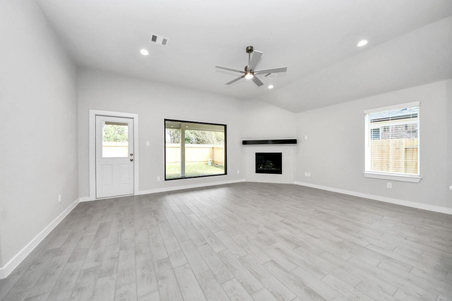 Welcome family and guests to your charming living room! With its high ceilings, recessed lighting, ceiling fan, custom paint, beautiful flooring, and large windows that let in abundant natural light, this room is perfect for gatherings. Sample photo of completed home with similar floor plan. Actual colors and selections may vary. Welcome family and guests to your charming living room! With its high ceilings, recessed lighting, ceiling fan, custom paint, beautiful flooring, and large windows that let in abundant natural light, this room is perfect for gatherings. Sample photo of completed home with similar floor plan. Actual colors and selections may vary.