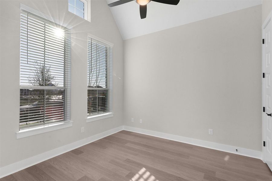 Unfurnished room with light wood-style flooring, ceiling fan, and high vaulted ceiling