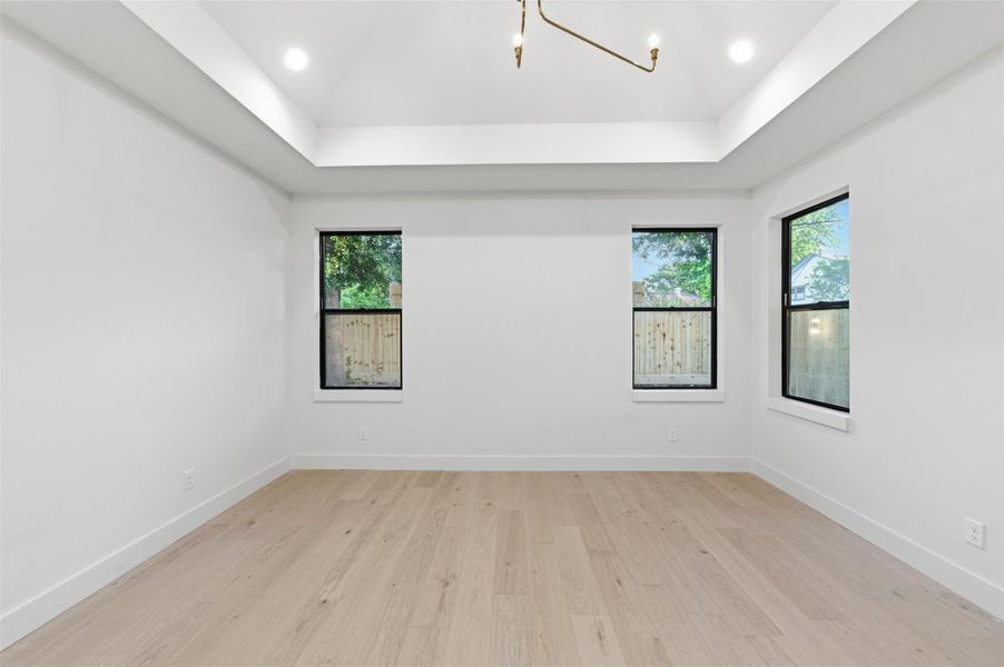 This elegant primary bedroom offers the perfect blend of comfort and sophistication, creating a true private retreat.