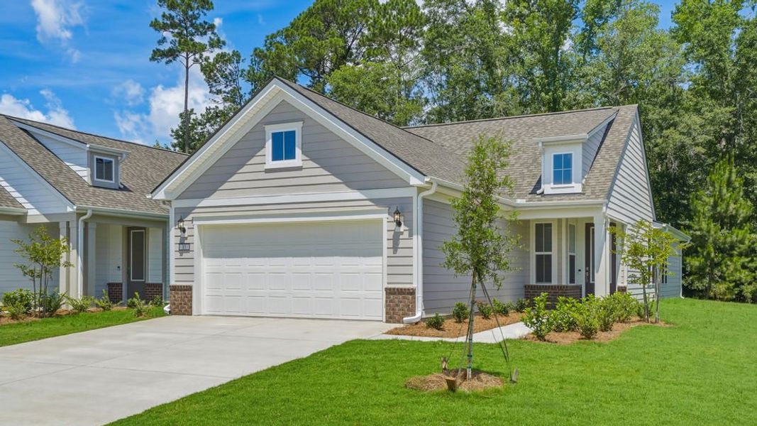 Front exterior of a new home in Sun City Hilton Head, Bluffton, SC, highlighting curb appeal (Image 22). Front exterior of a new home in Sun City Hilton Head, Bluffton, SC, highlighting curb appeal (Image 22).