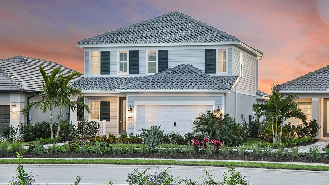 Front exterior of a new home in SkySail Real Estate and Homes for Sale in Naples, FL - Neal Communities, Naples, FL, highlighting curb appeal (Image 20).