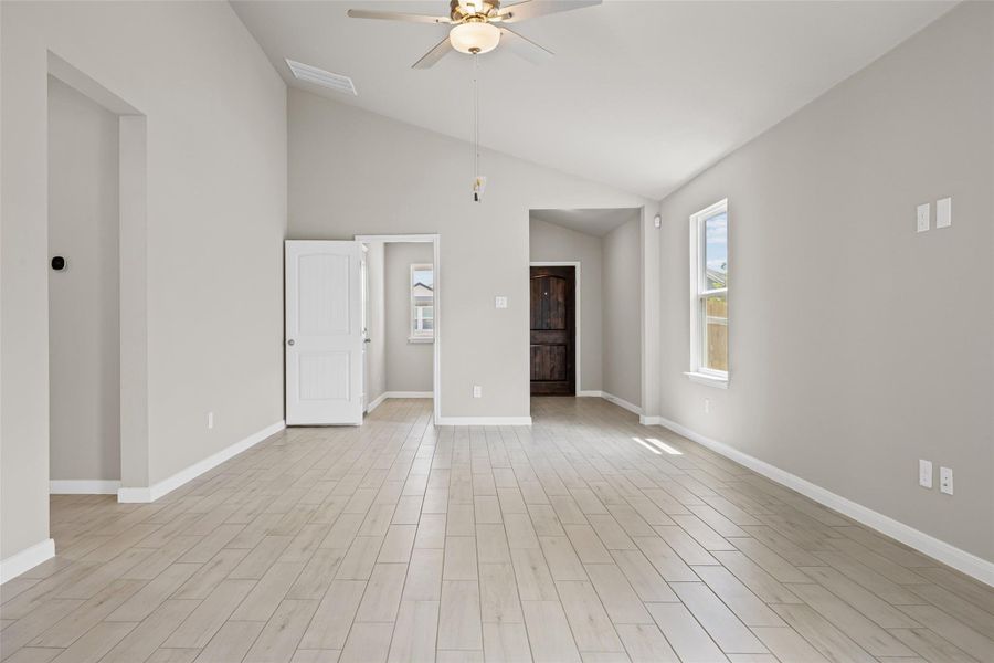 Vaulted ceilings and wood-look tile flooring create an airy atmosphere throughout the main living space. Vaulted ceilings and wood-look tile flooring create an airy atmosphere throughout the main living space.