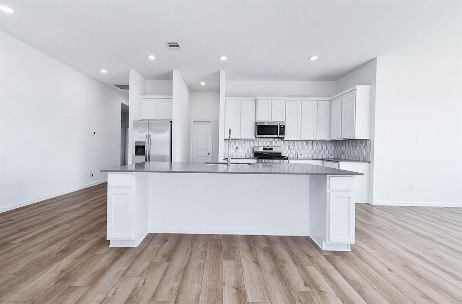 A chef's dream kitchen! Stainless steel appliances, a spacious island with quartz countertops, and sleek cabinetry create a space where cooking meets sophistication.