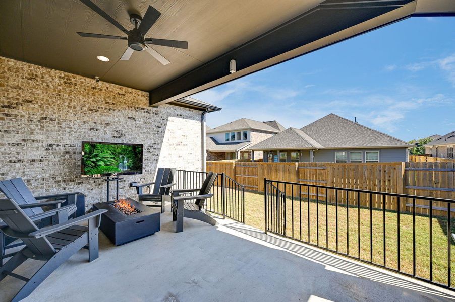 The coverage patio has a ceiling fan & is prepared for an outdoor t.v.