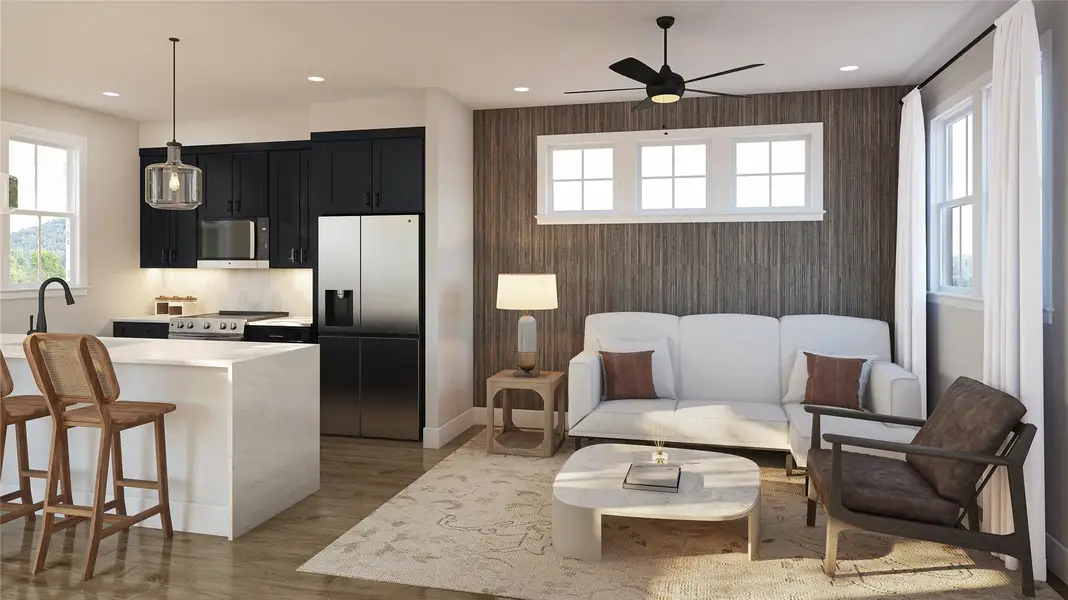 Kitchen featuring dark cabinetry, appliances with stainless steel finishes, a breakfast bar area, light wood-type flooring, and a ceiling fan Kitchen featuring dark cabinetry, appliances with stainless steel finishes, a breakfast bar area, light wood-type flooring, and a ceiling fan