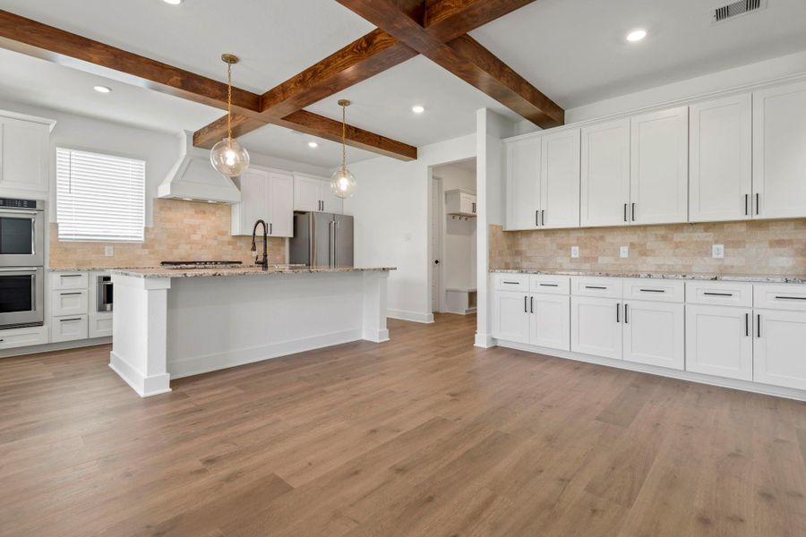 The kitchen and adjoining dining room feature beautiful ceiling beams.