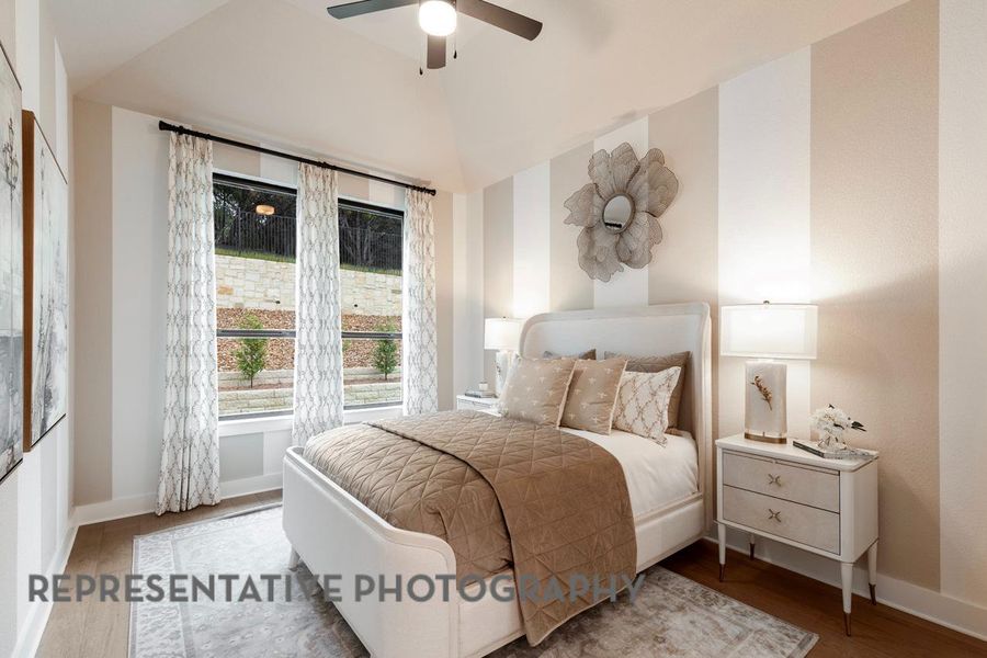 Bedroom with baseboards, a ceiling fan, and lofted ceiling Bedroom with baseboards, a ceiling fan, and lofted ceiling