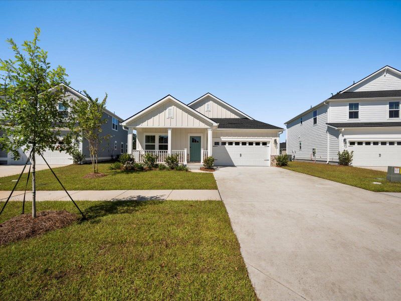 Front exterior of a new home in The Coves at Lakes of Cane Bay, Summerville, SC, highlighting curb appeal (Image 26). Front exterior of a new home in The Coves at Lakes of Cane Bay, Summerville, SC, highlighting curb appeal (Image 26).