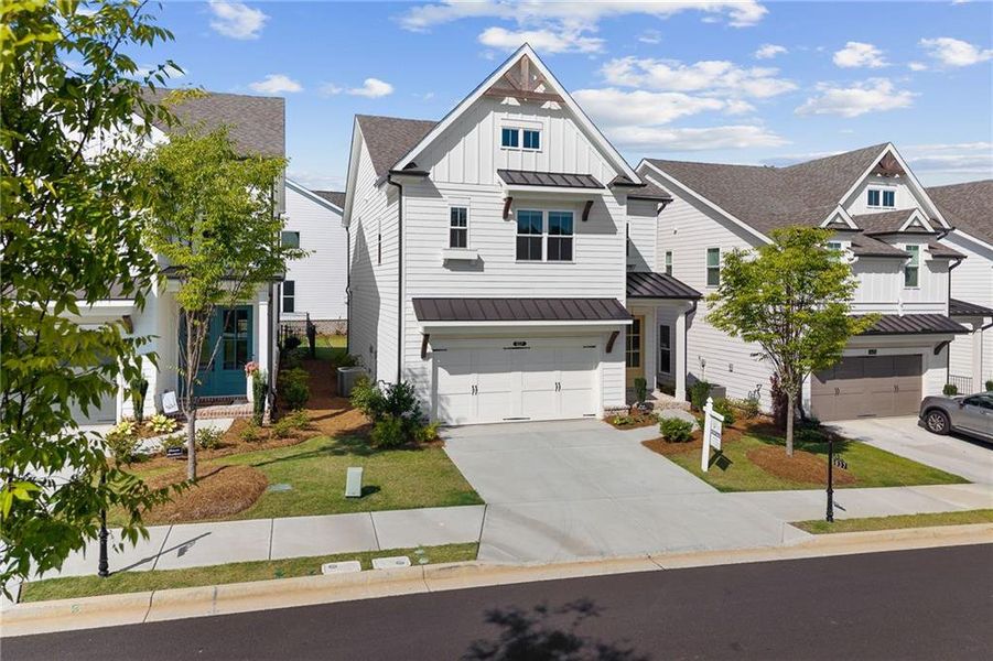 Front exterior of a new home in Palisades Single Family, Cumming, GA, highlighting curb appeal (Image 1). Front exterior of a new home in Palisades Single Family, Cumming, GA, highlighting curb appeal (Image 1).