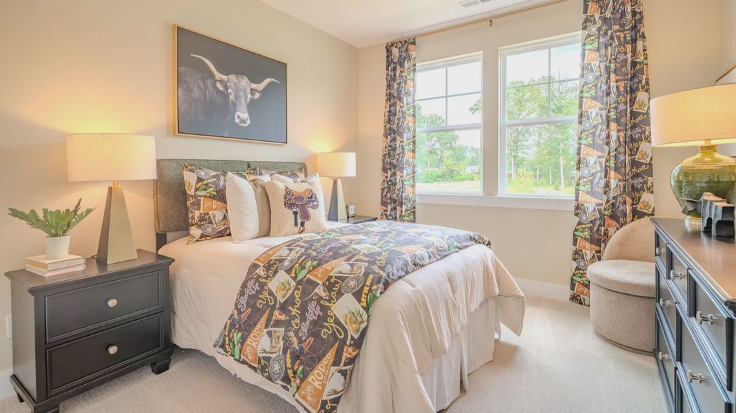 Secondary bedroom with carpet and bright natural light from windows Secondary bedroom with carpet and bright natural light from windows
