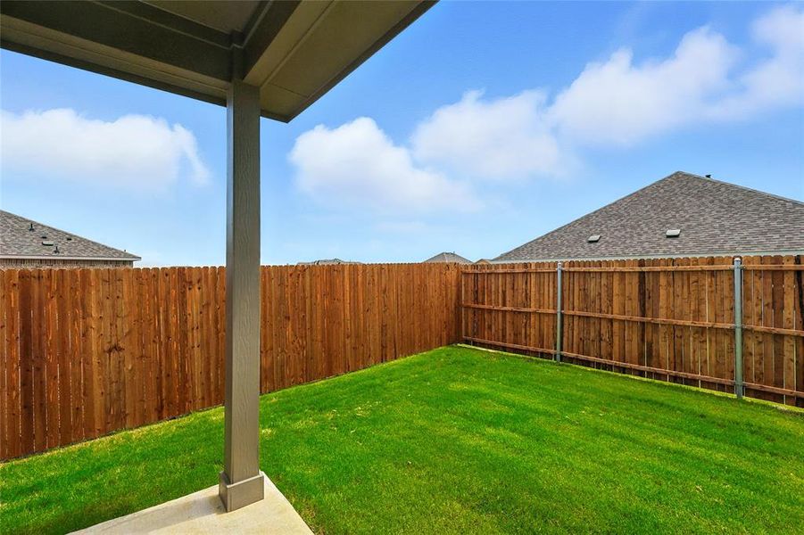 Fenced backyard featuring a patio area Fenced backyard featuring a patio area