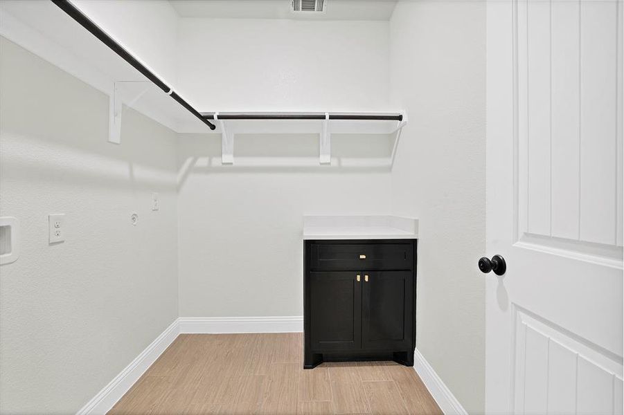 Spacious closet with light wood-type flooring