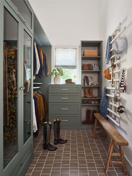 The primary closet is outfitted with the Preston closet system from Container Store.