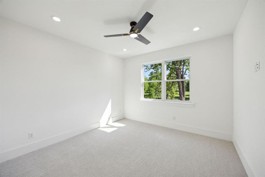 Upstairs bedroom featuring light colored carpet, ceiling fan, and recessed lighting Upstairs bedroom featuring light colored carpet, ceiling fan, and recessed lighting