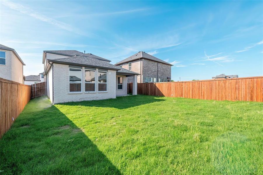 Back of property with roof with shingles and brick siding Back of property with roof with shingles and brick siding