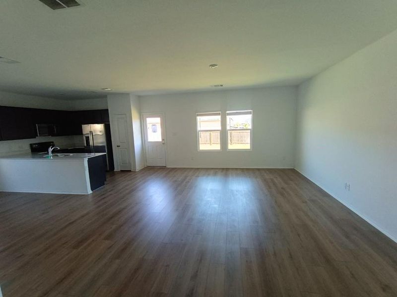 Unfurnished living room featuring dark wood finished floors Unfurnished living room featuring dark wood finished floors