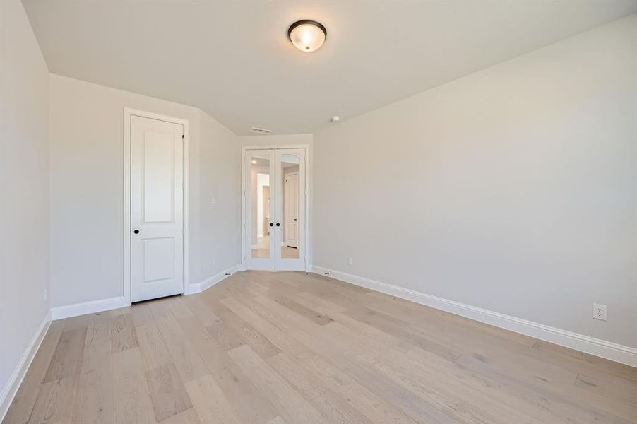 Unfurnished bedroom with a closet and light hardwood / wood-style floors