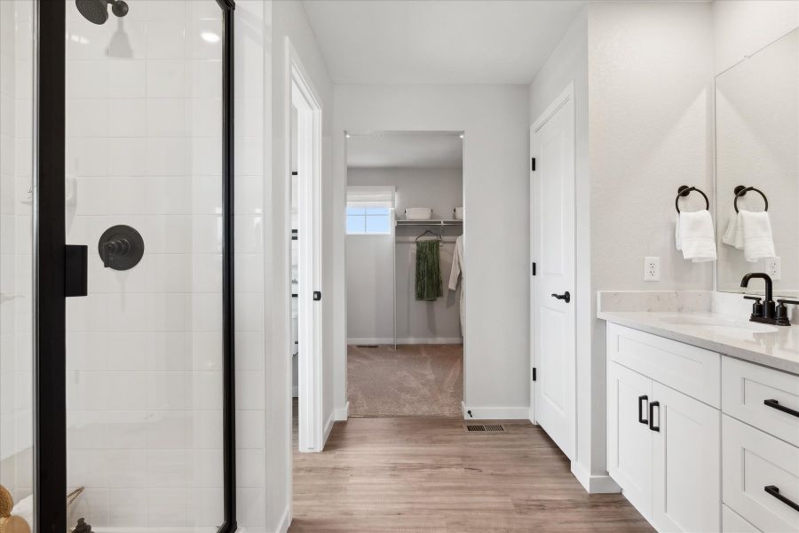 A bathroom with a glass shower. A bathroom with a glass shower.