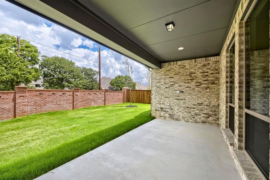 Covered patio with concrete flooring, recessed lighting, and a modern exterior light fixture Covered patio with concrete flooring, recessed lighting, and a modern exterior light fixture