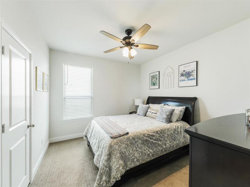 Bedroom with ceiling fan and carpet floors