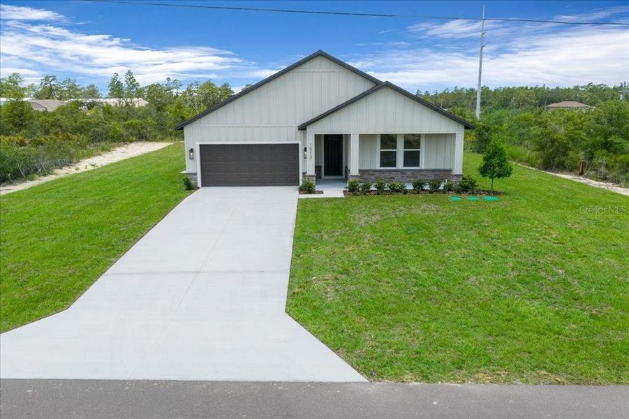 Front exterior of a new home in , Weeki Wachee, FL, highlighting curb appeal (Image 27). Front exterior of a new home in , Weeki Wachee, FL, highlighting curb appeal (Image 27).